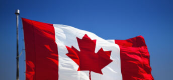 The Canadian flag blows in the wind.