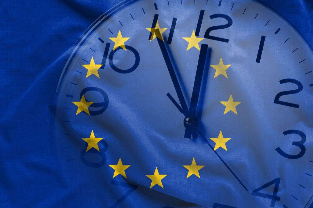 Composite image of EU flag and clock Double exposure of clock and blue flag of European Union