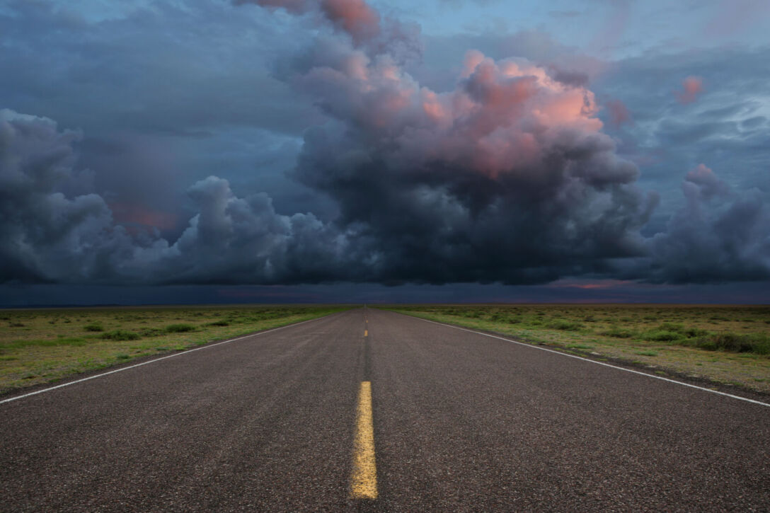 Desert road with storm clouds