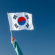 Hand waving the Korean flag.