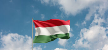 Flag Hungary against cloudy sky. Country, nation, union, banner, government, Hungarian culture, politics. 3D illustration