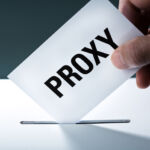 Investors launch ‘vote no’ campaign at Starbucks over labour rights Voter's hand holding a proxy vote ballot, inserting the vote card into the ballot box.