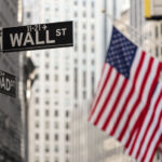 New York State comptroller calls for ‘good faith’ engagement amid SEC no-action move Wall street sign in New York City with American flags and New York Stock Exchange in background.